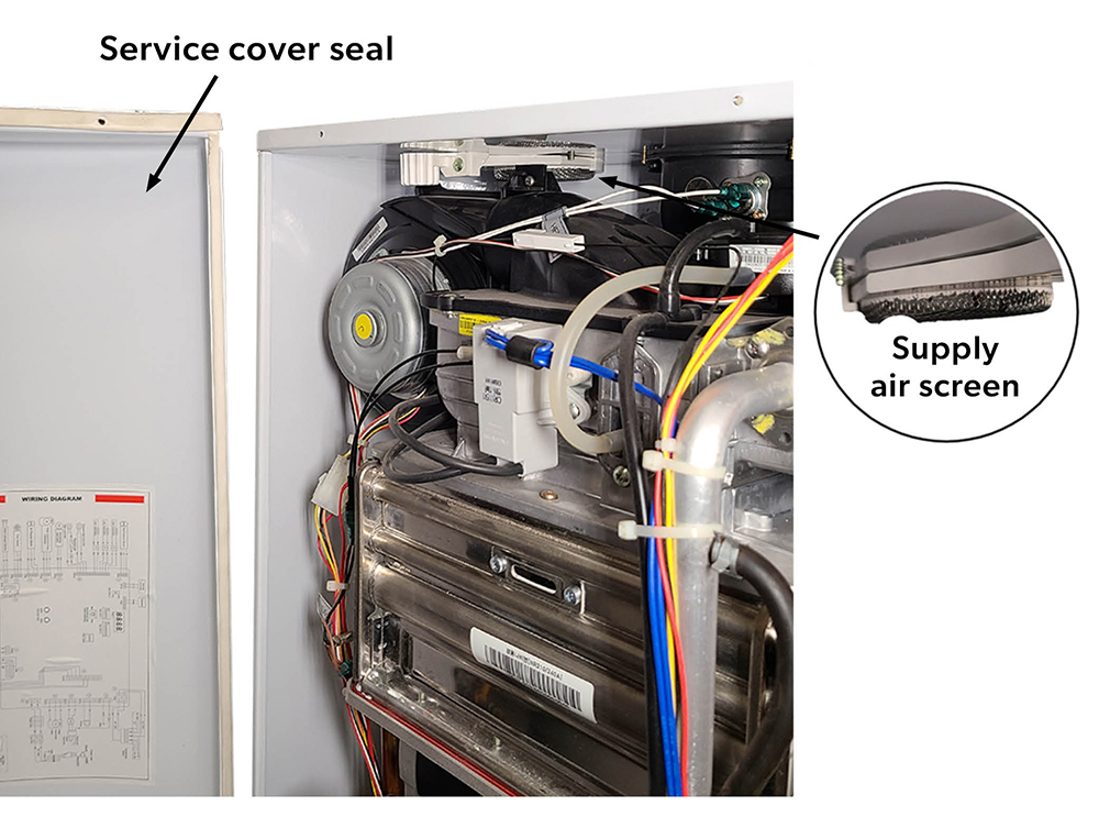 A wall-hung on-demand water heater. The service cover seal is shown on the cover and the supply air screen is highlighted at the top.