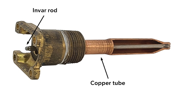 A rod and tube temperature sensory with the invar rod and copper tube labelled.