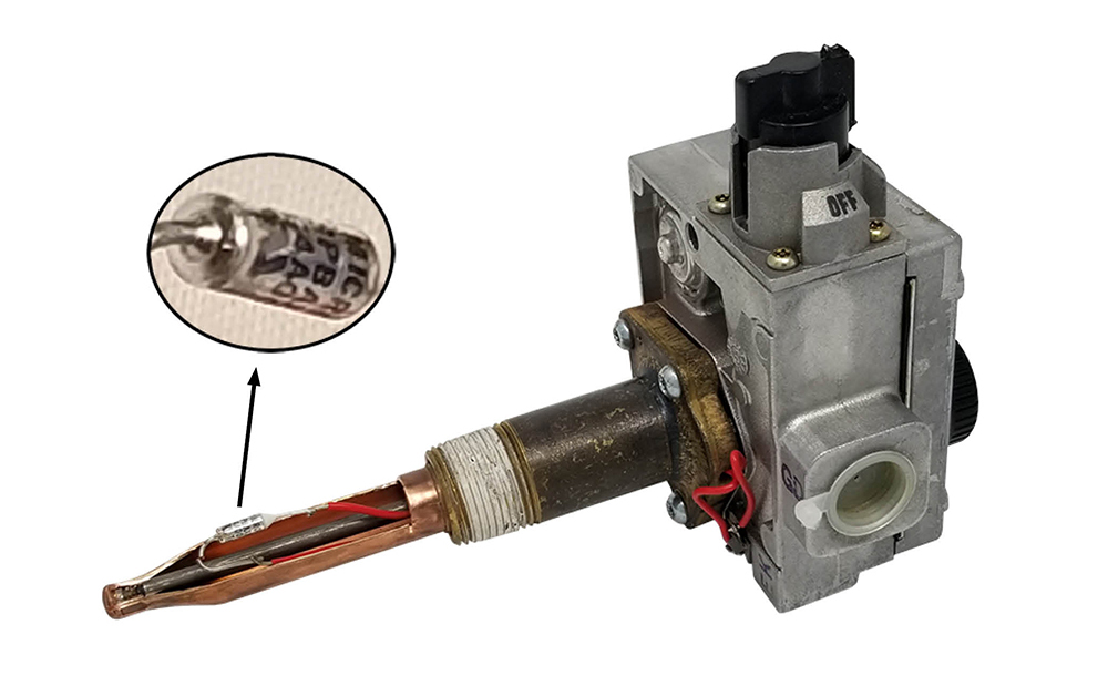 An Energy cut-off device, or ECO. A cutaway image shows a closer image of the fuse. The fuse is silver and cylindrical, with writing in-cut into the side.